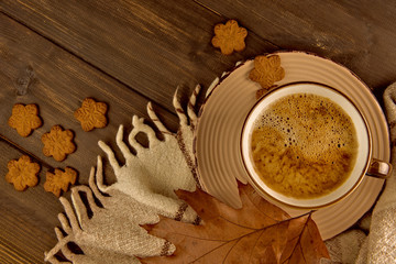 Cup of hot coffee Christmas sweet cookies plaid with brown oak leaves top view on wooden background