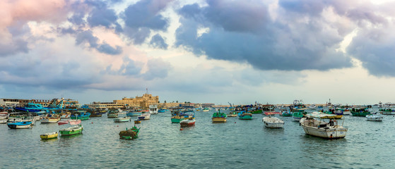 ALEXANDRIA, EGYPT - NOVEMBER 20, 2016: Cityscape with egyptian fisher boats, vessels and ships in...