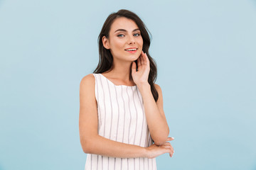 Happy excited young woman posing isolated over blue background wall.