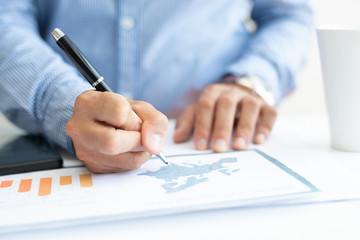 Closeup of marketing expert analyzing bar chart. Person working at desk. Analytics concept. Cropped front view.