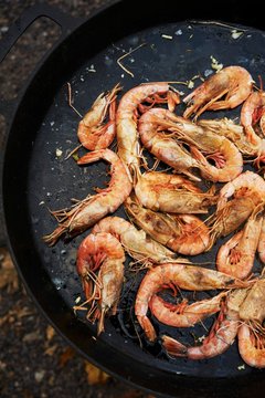 Deep Water Gulf Prawns Sauteing in a Cast Iron Skillet; Outside