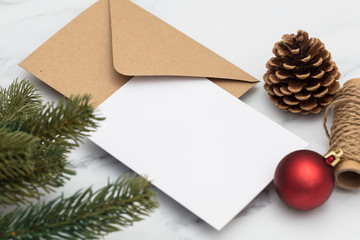 Blank white christmas card composition. Fir branch, festive seasonal decorations, lay flat background template