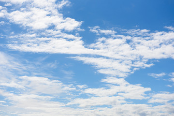 Fluffy white clouds in blue sky background