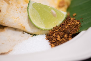 Sliced lime sugar and ground chili