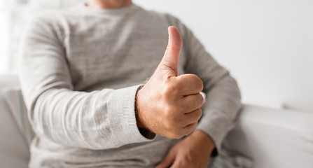 old age, gesture and people concept - close up of senior man showing thumbs up