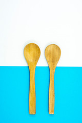 Wooden spoon on blue and white background