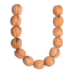 Letter U made with nuts to form a letter of the alphabet. Fruit letters on a white background.