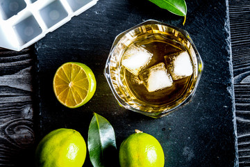 glass of scotch on dark wooden background top view