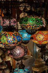 Lamps, lanterns, lamps of multicolored glass mosaic in the street market of the market in Istanbul,...