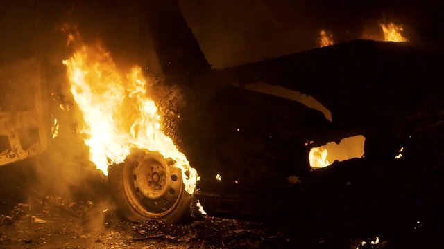Car In Fire At Night, Burning Car Wheel, Rear View