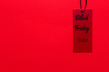 Black Friday. Discounts,sale, label, tags of popular trend of companies on a red background with copy space and the words Black Friday flat lay top view.
