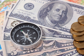 Travel & Exploration Concept : Compass Notebank and coin on World map.