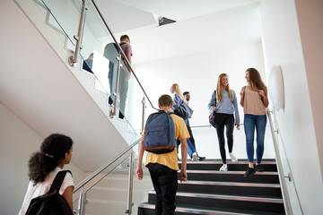 High School Students Walking On Stairs Between Lessons In Busy College Building - Powered by Adobe