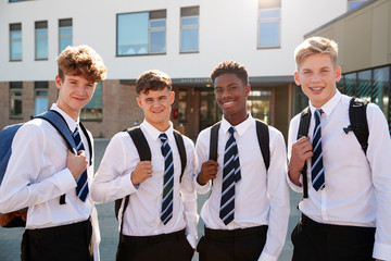 Portrait Of Smiling Male High School Students Wearing Uniform Outside College Building