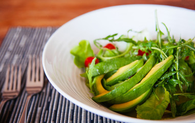 Avocado Arugula and cherry tomatoes salad with light dressing