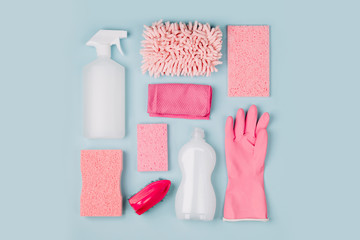 Detergents and cleaning accessories  in pink color.  Cleaning service concept. Flat lay, Top view.