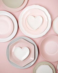 Plates and dishes for serving a festive table on pastel colors background. Flat lay, top view.