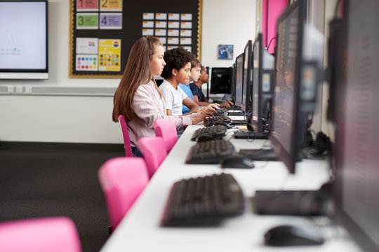 Line Of High School Students Working at Screens In Computer Class