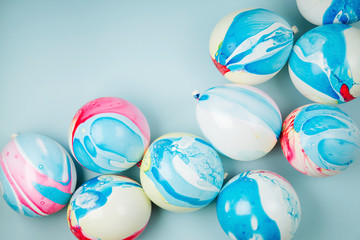 Colorful balloons on pastel color background. Festive or birthday party concept. Flat lay, top view.