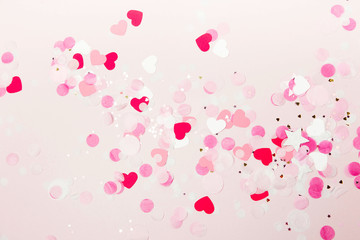 Background of pale pink paper confetti shape of heart, holiday concept