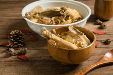 chicken soup with wooden background