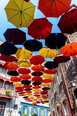 Lot of colorful umbrellas in the street of old Québec 