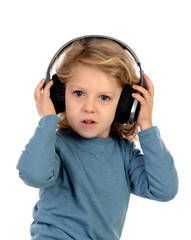 Happy blond child with headphones an blue t-shirt