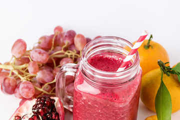 Healthy Detox Smoothies on a White Background With Fruits Citrus Grape Pomegranate Glass Jar of Tasty Smoothie Horizontal
