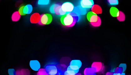 festive background. blurred colored lights on a black background