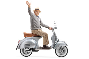 Senior gentleman riding a vintage scooter and waving at the camera