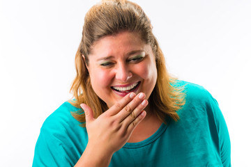 Portrait of cheerful fatty woman against white background