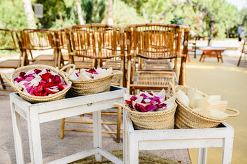 Petals of red roses in baskets to throw to the newlyweds.