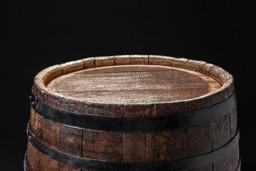 Old wooden barrel on a dark background