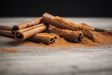Cinnamon sticks on wooden background.
