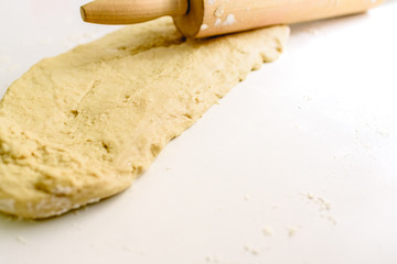 Cooking and kneading the pizza dough on the white table