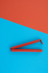 Plastic sealing clip on red and blue background.