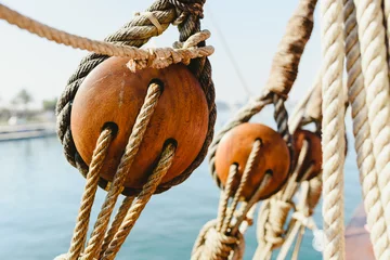 Garden poster Schip Rigging and ropes on an old sailing ship to sail in summer.