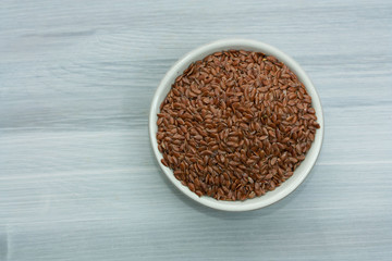 Brown linseeds in a bowl.