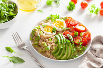 quinoa with boiled egg, avocado, tomato, arugula. healthy breakfast