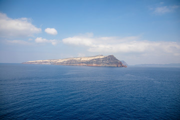 View of Thirasia from sea next to Santorini, Greece