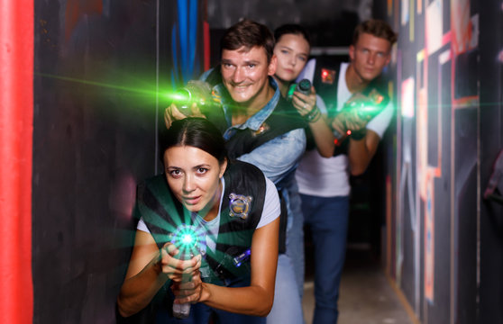 Group glad people playing laser tag  game