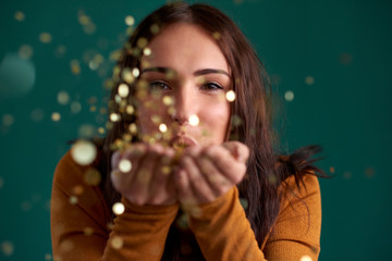 Beautiful stylish woman blowing confetti party celebration