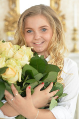 Cute curly teen girl posing with bouquet