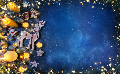Christmas background with wooden decorations and candles. Free space for text
