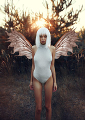Girl with butterfly wings in the forest