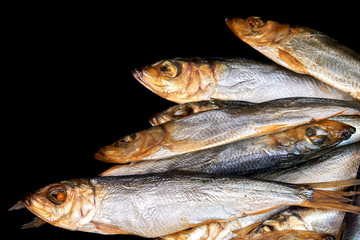 Smoked fish Baltic herring isolated on black background