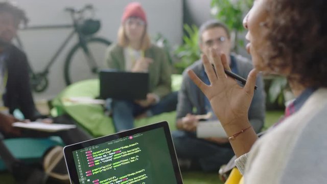 young business people meeting programmers brainstorming software developers discussing code sharing ideas for project using laptop computer technology enjoying intelligent communication in office