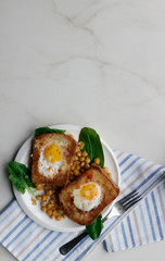 Toast with egg in white plate on white marble background. Healthy breakfast