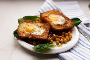 Toast with egg in white plate on white marble background. Healthy breakfast
