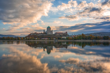 Amazing sunrise view over Danube river, beautiful reflections of morning clouds mirrored in water, Esztergom, Hungary